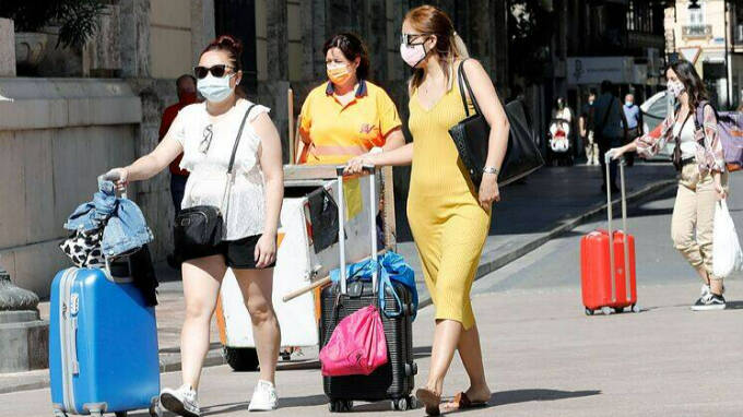 Unas turistas con mascarilla por Valencia