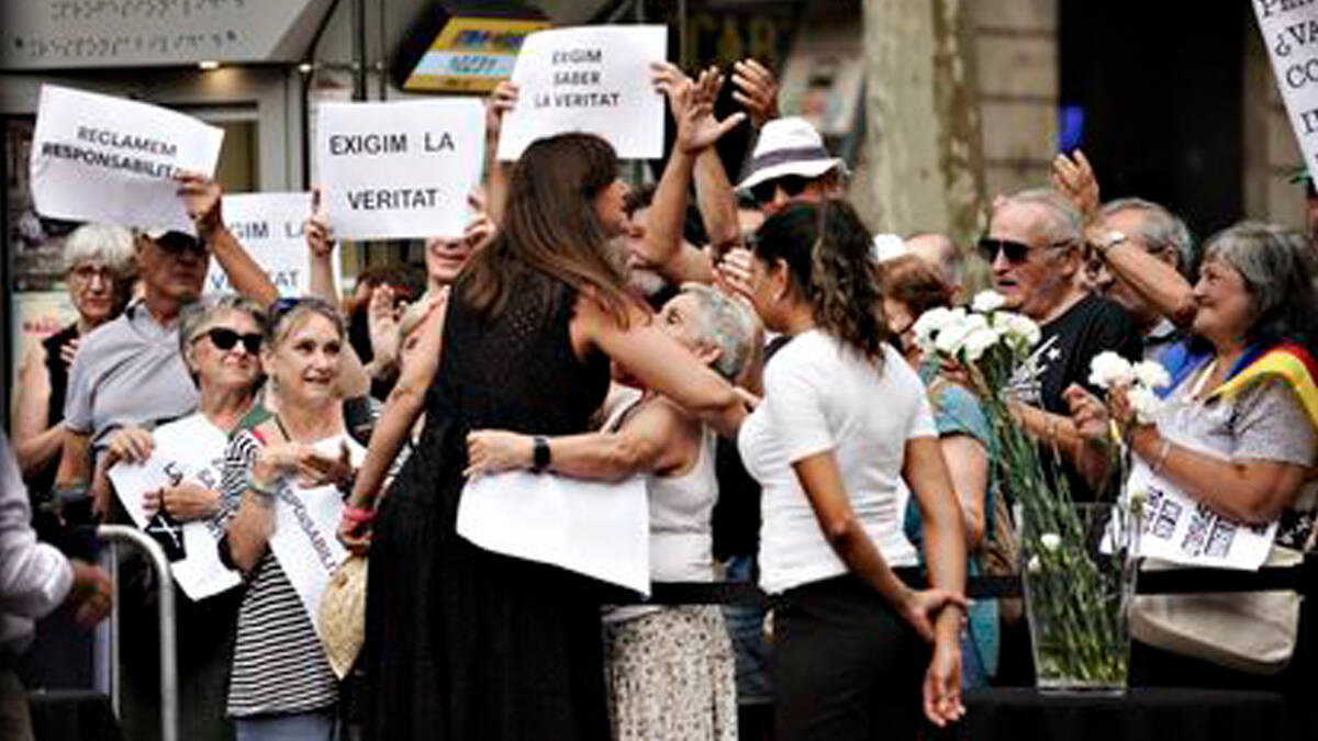 Laura Borràs se abraza con los manifestantes que han boicoteado el homenaje