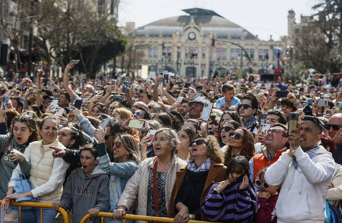 Decenas de personas durante la mascletà de la plaza del Ayuntamiento de Valencia.