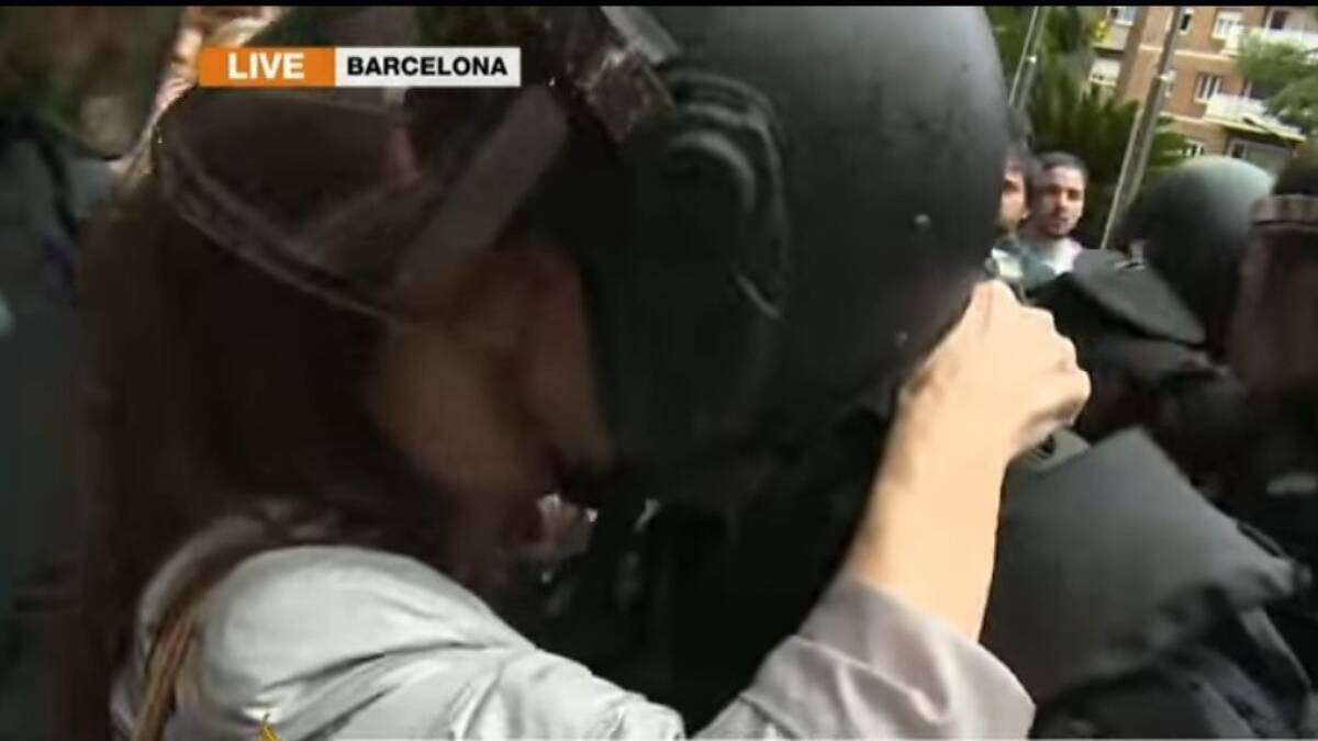 Imagen del momento del beso de una manifestante al policía antidisturbios que ahora, cinco años después, ha denunciado.