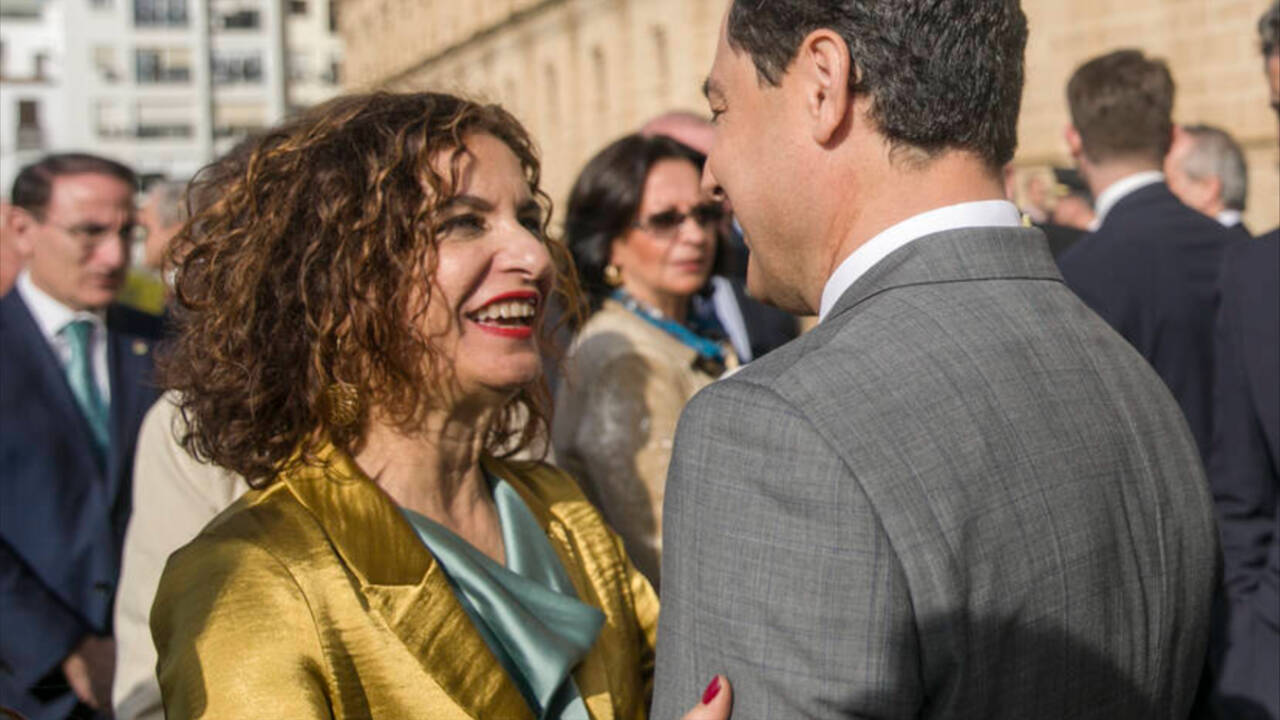 La ministra de Hacienda, María Jesús Montero, saluda al presidente de la Junta de Andalucía, Juanma Moreno, en un acto en Sevilla.