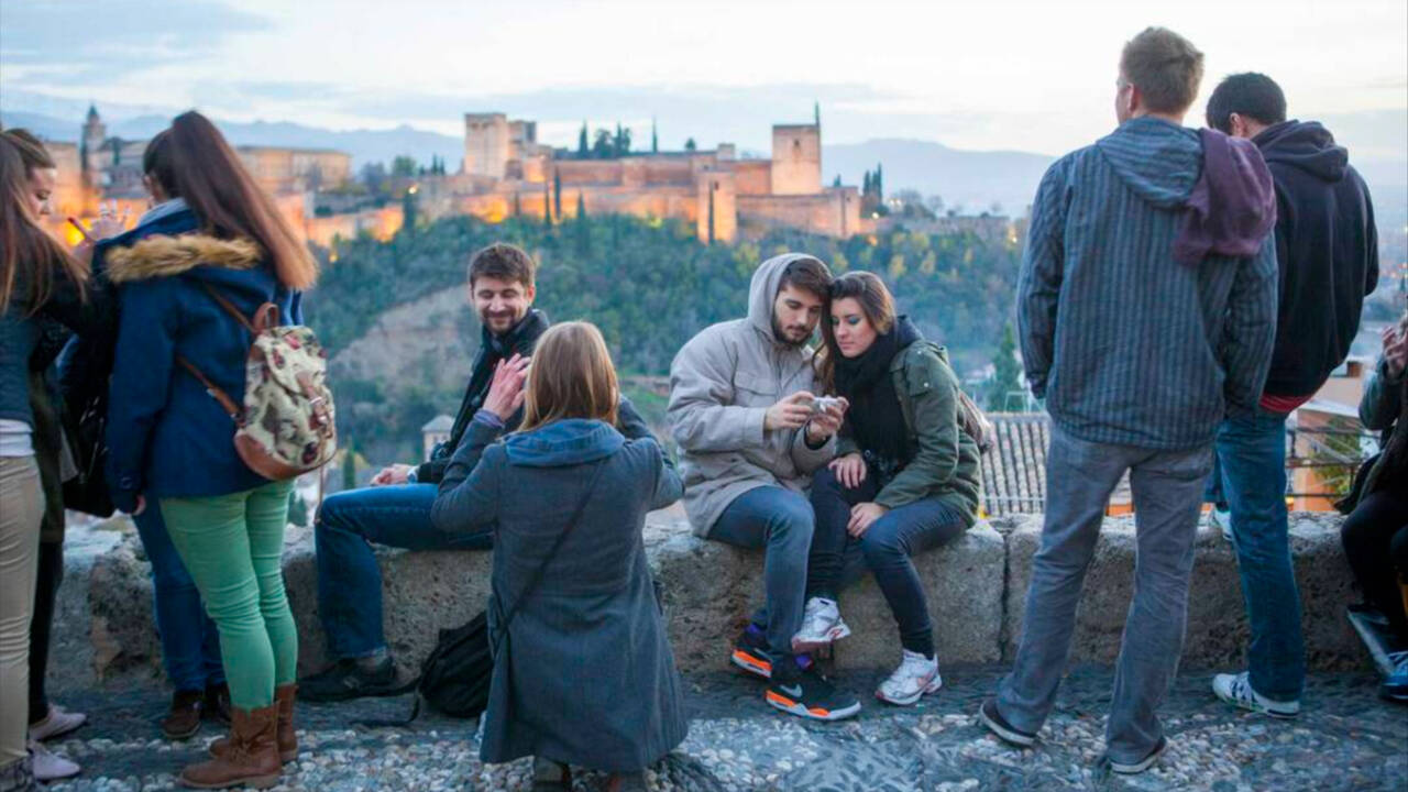 Turistas en el mirador de San Nicolás, Granada, con vistas a la Alhambra.